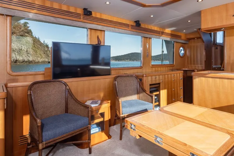 Raindancer Yacht Photos Pics Luxurious interior of 2009 Selene 60 Ocean Trawler with wood paneling and scenic ocean view.