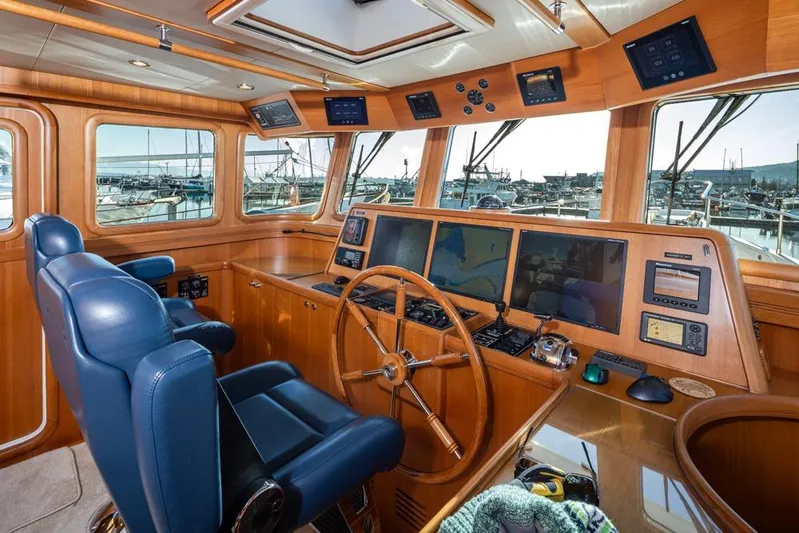 Raindancer Yacht Photos Pics Luxurious helm of 2009 Selene 60 Ocean Trawler with advanced navigation systems and leather seating.