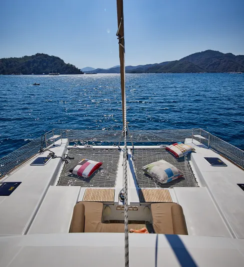  Yacht Photos Pics Lagoon 52 F catamaran sailing on blue waters with scenic island views, 2014 model.