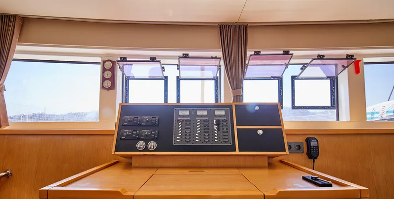  Yacht Photos Pics Interior helm of 2014 Lagoon 52 F catamaran with control panel and windows.