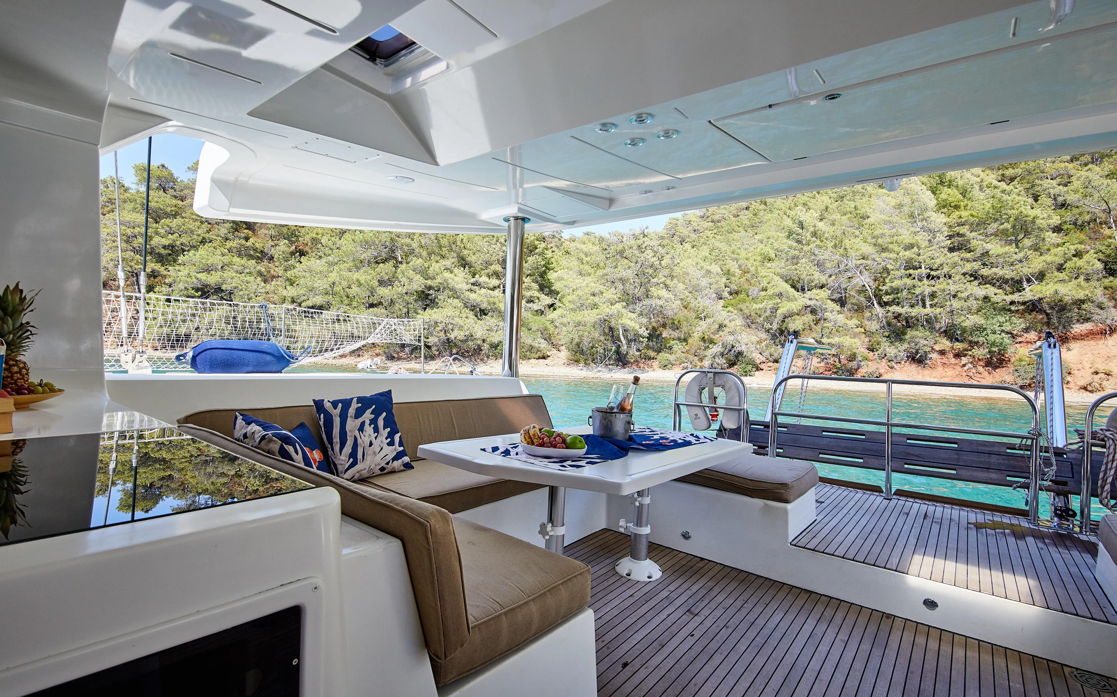  Yacht Photos Pics Luxurious Lagoon 52 F yacht interior with seating, table, and scenic ocean view, 2014 model.