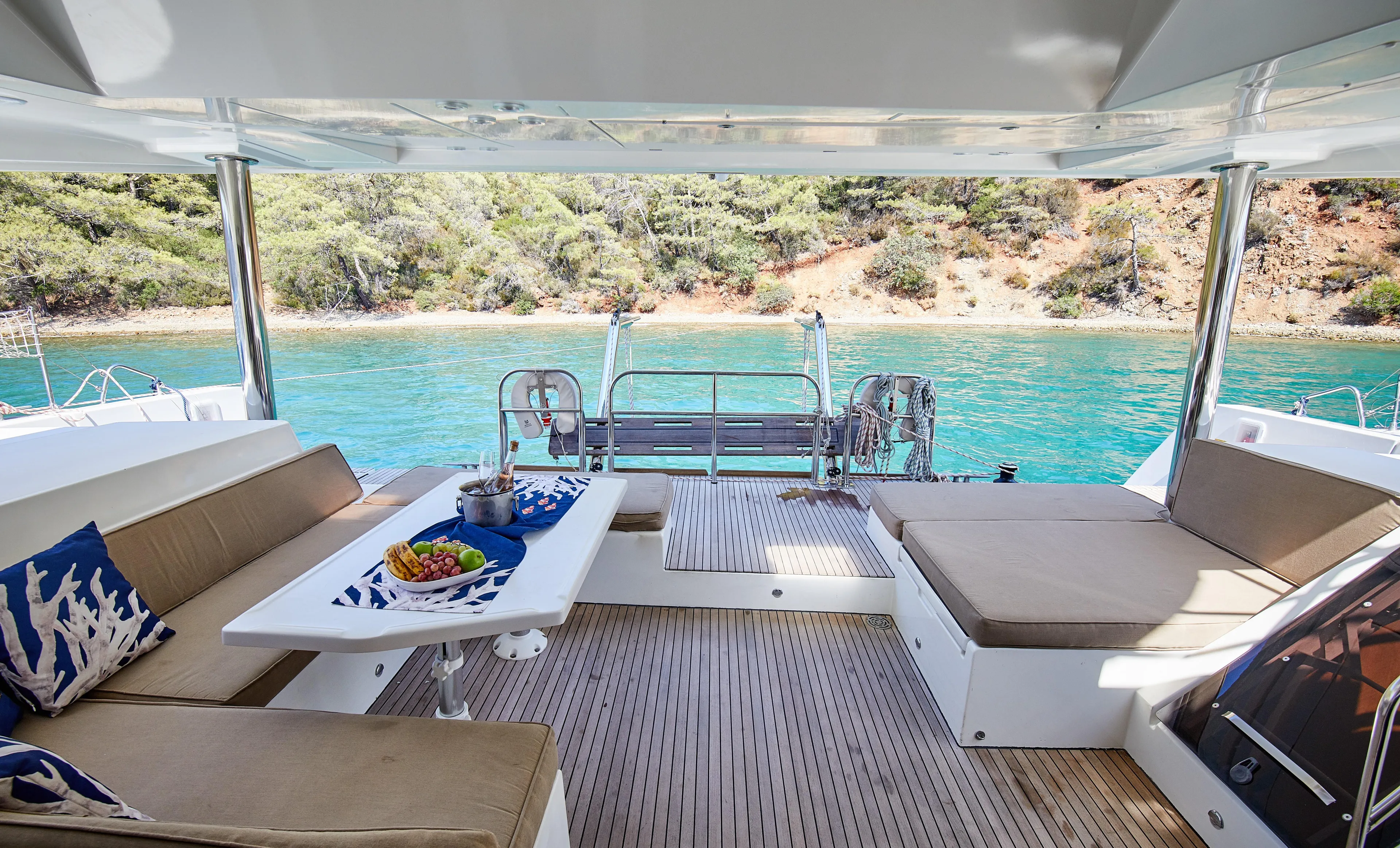  Yacht Photos Pics Luxurious Lagoon 52 F yacht deck with seating, table, and scenic ocean view, 2014 model.