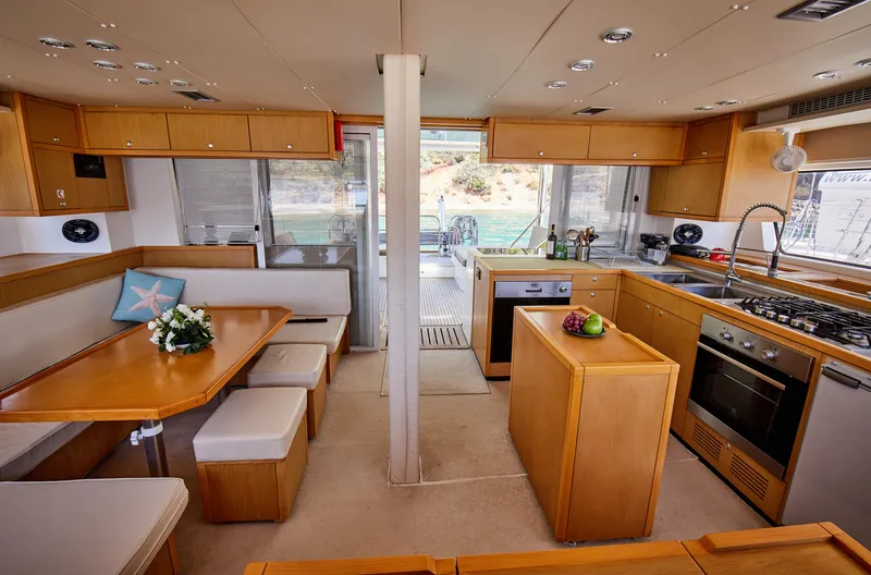  Yacht Photos Pics Interior of 2014 Lagoon 52 F yacht with modern kitchen and dining area.