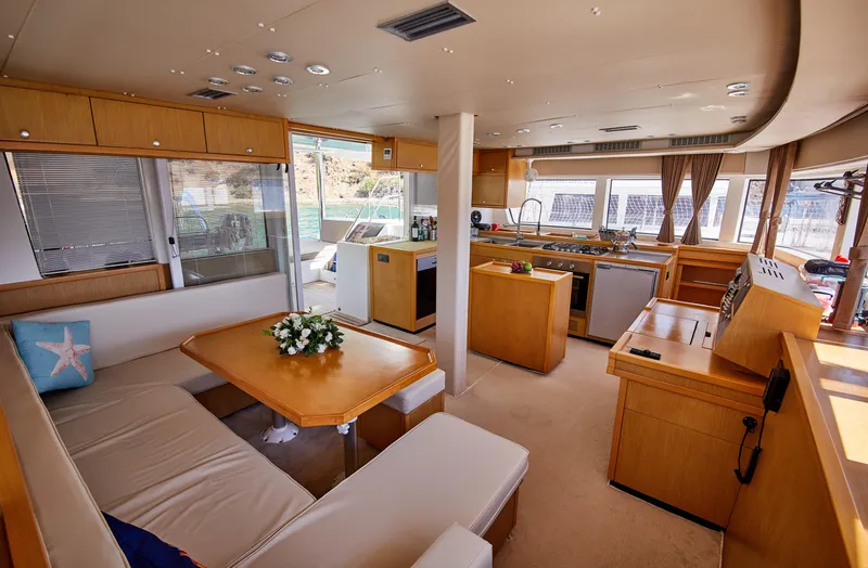  Yacht Photos Pics Luxurious interior of 2014 Lagoon 52 F yacht with modern kitchen and dining area.