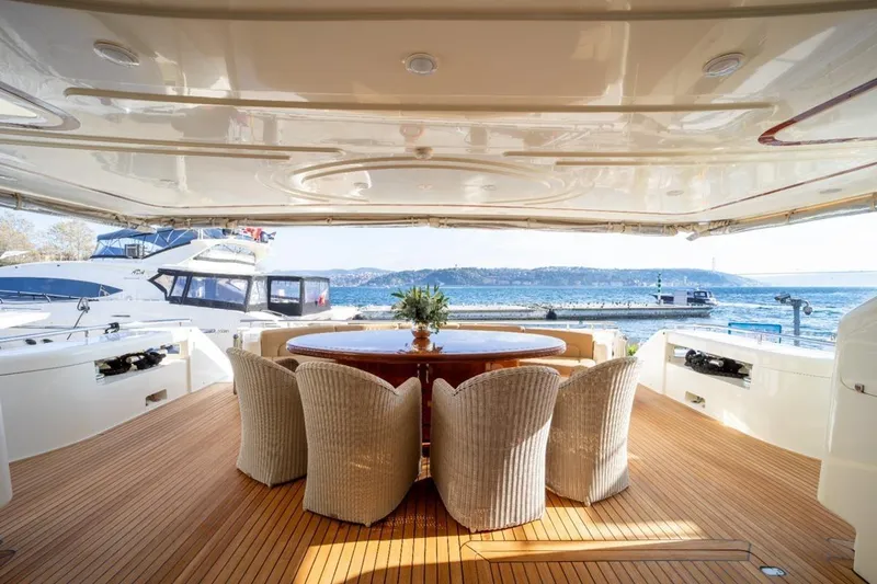  Yacht Photos Pics Luxurious 1999 Ferretti Customline 94 yacht with elegant outdoor dining area.