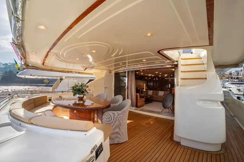  Yacht Photos Pics Luxurious 1999 Ferretti Customline 94 yacht interior with elegant seating and wooden deck.