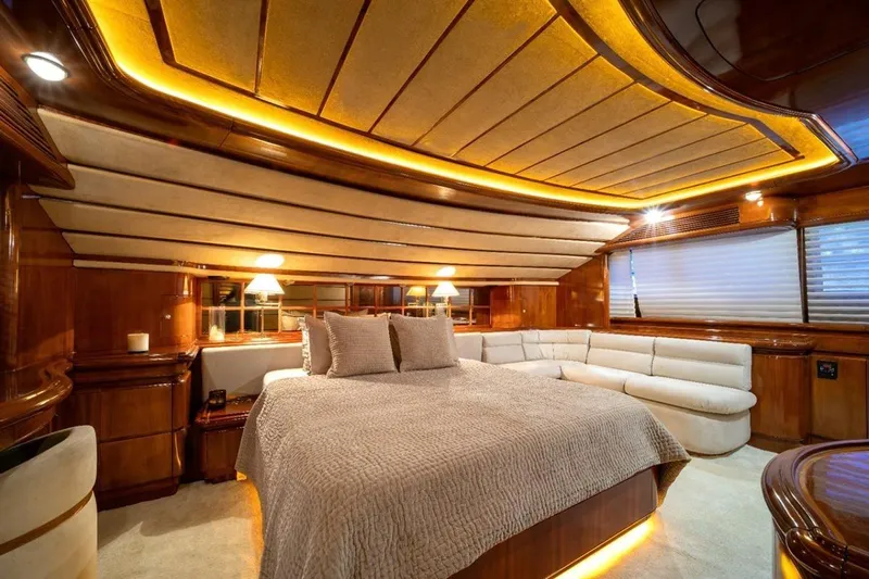  Yacht Photos Pics Luxurious bedroom interior of 1999 Ferretti Customline 94 yacht with elegant wood finishes.