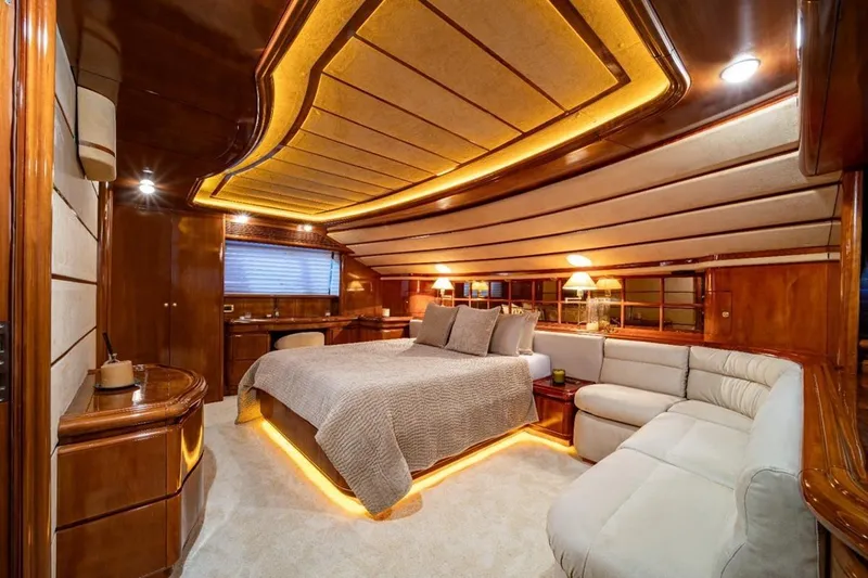  Yacht Photos Pics Luxurious Ferretti Customline 94 yacht bedroom, 1999 model, featuring elegant wood finishes and ambient lighting.