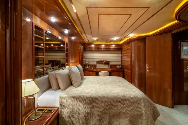  Yacht Photos Pics Luxurious bedroom interior of 1999 Ferretti Customline 94 yacht with elegant wood finishes.