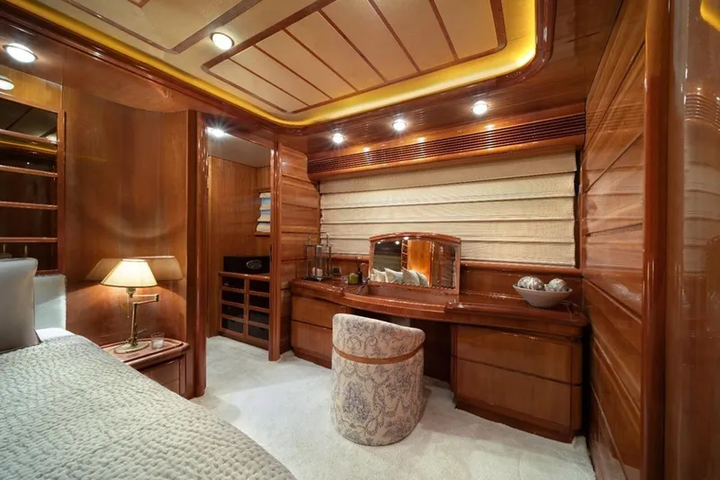  Yacht Photos Pics Luxurious wooden interior of 1999 Ferretti Customline 94 yacht cabin with elegant furnishings.
