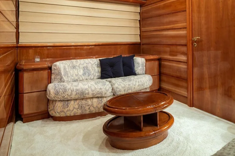  Yacht Photos Pics Luxurious interior of 1999 Ferretti Customline 94 yacht with elegant wood paneling and plush seating.