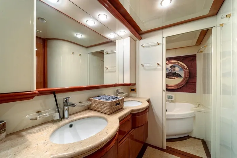  Yacht Photos Pics Luxurious bathroom in 1999 Ferretti Customline 94 yacht with dual sinks and elegant decor.