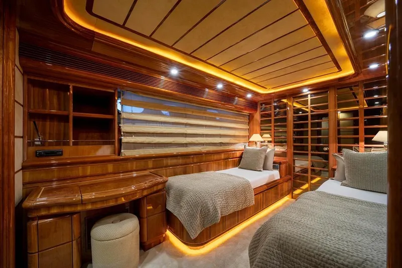  Yacht Photos Pics Luxurious 1999 Ferretti Customline 94 yacht cabin with twin beds and elegant wood finish.