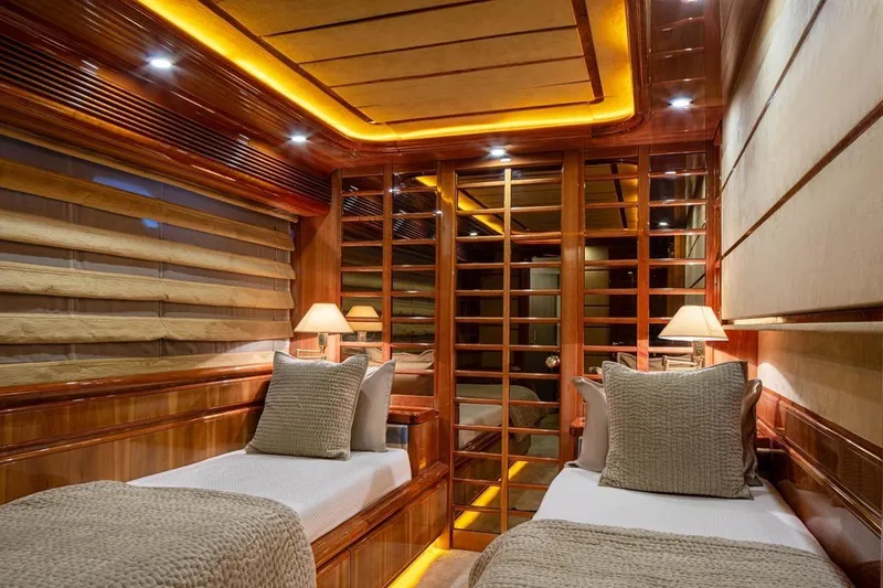  Yacht Photos Pics Luxurious cabin interior of 1999 Ferretti Customline 94 yacht with twin beds and warm lighting.