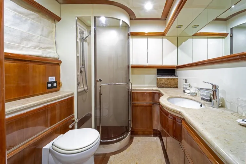  Yacht Photos Pics Luxurious bathroom on 1999 Ferretti Customline 94 yacht with elegant wood finishes.