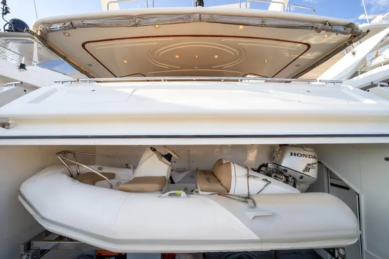  Yacht Photos Pics 1999 Ferretti Customline 94 yacht with a stored inflatable boat and Honda outboard motor.