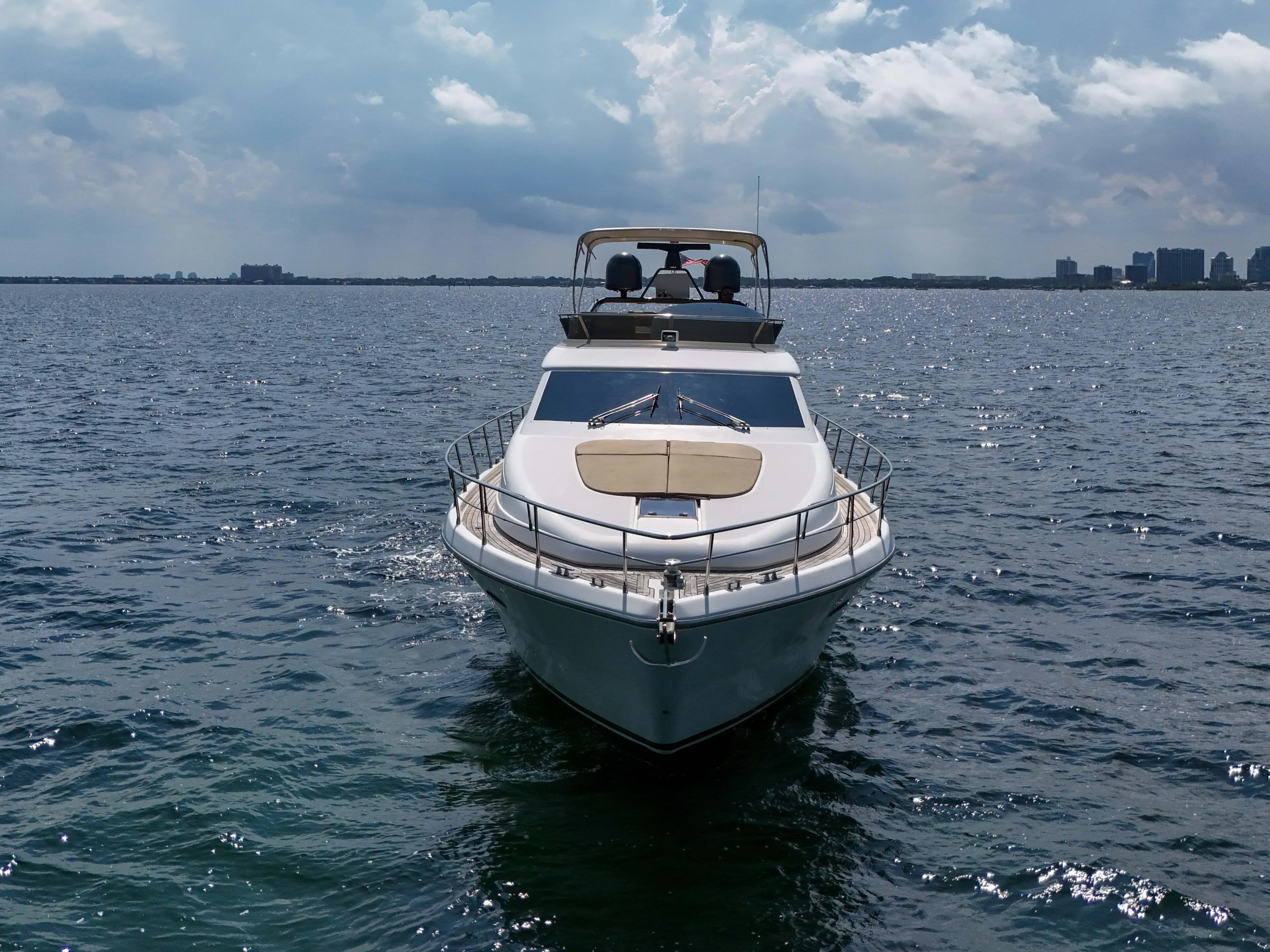  Yacht Photos Pics 2006 Uniesse 58 yacht cruising on open water under a partly cloudy sky.