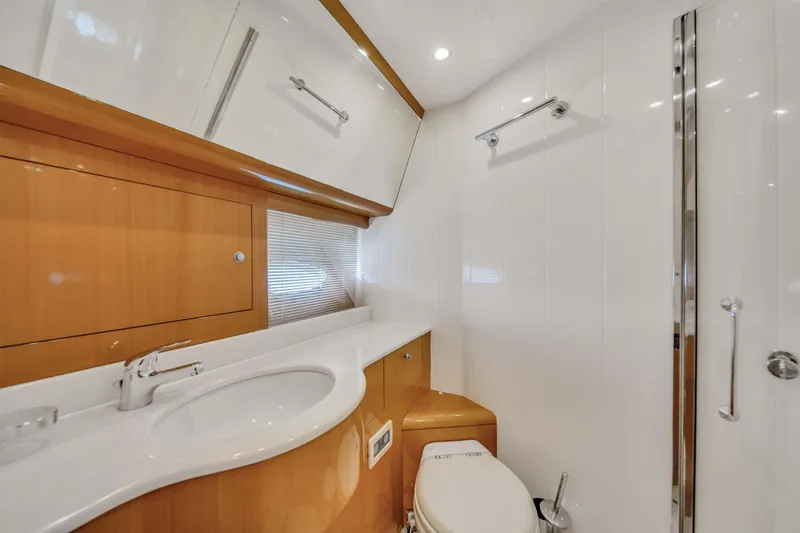  Yacht Photos Pics 2006 Uniesse 58 yacht bathroom with modern fixtures and wooden cabinetry.