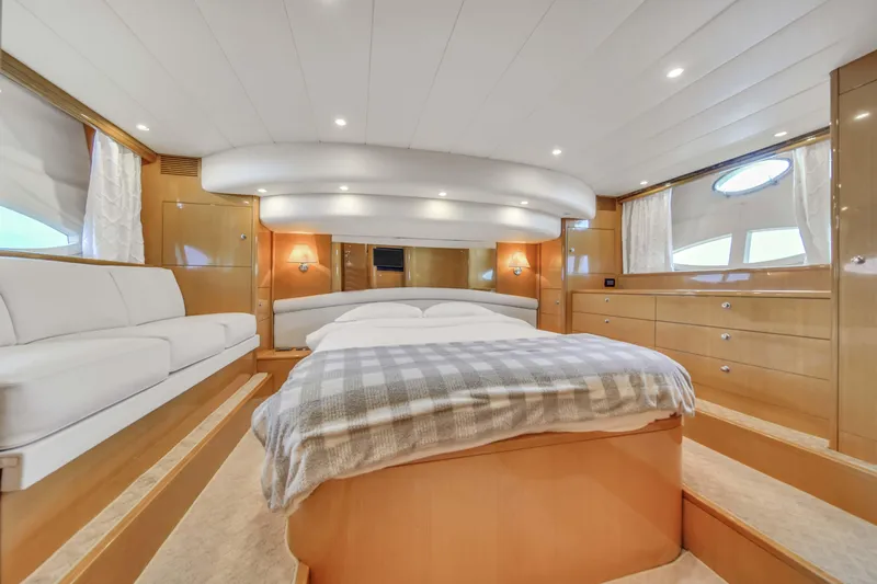  Yacht Photos Pics Luxurious master bedroom in a 2006 Uniesse 58 yacht with modern furnishings.
