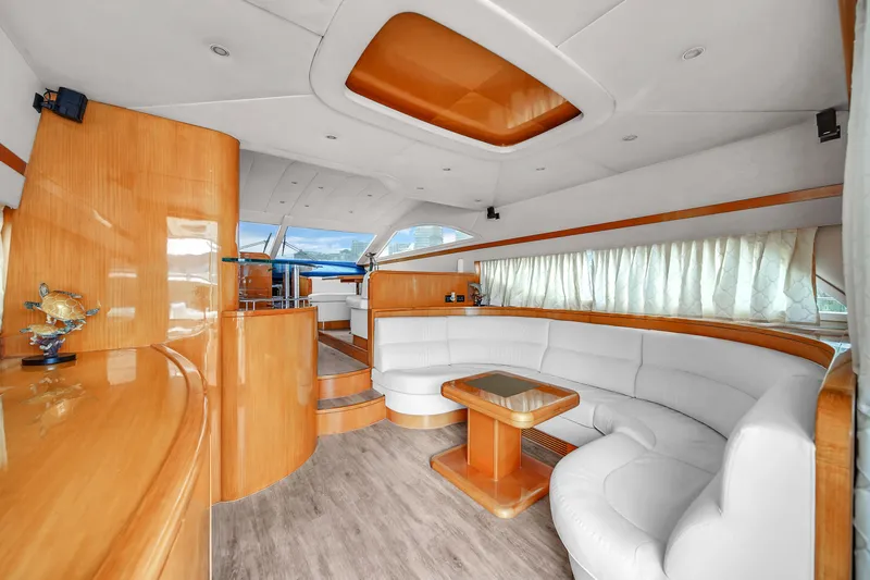  Yacht Photos Pics Luxurious interior of a 2006 Uniesse 58 yacht with white leather seating and wooden finishes.