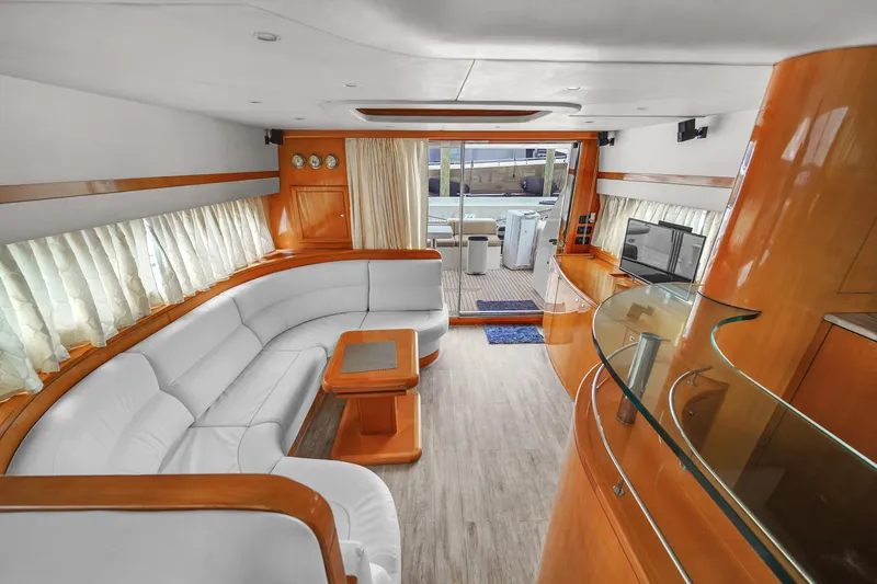  Yacht Photos Pics Luxurious interior of a 2006 Uniesse 58 yacht with white leather seating and wooden accents.