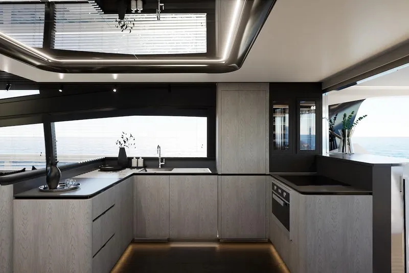  Yacht Photos Pics Modern kitchen interior on Pearl 73 yacht, 2027 model, featuring sleek cabinetry and ocean view.