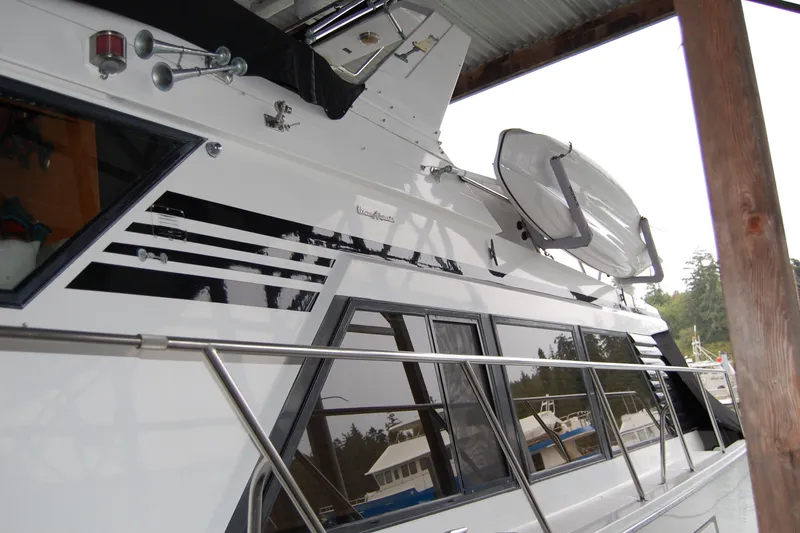 Sumptin Special Yacht Photos Pics 1990 Ocean Alexander 520 Pilothouse yacht docked under a covered area.