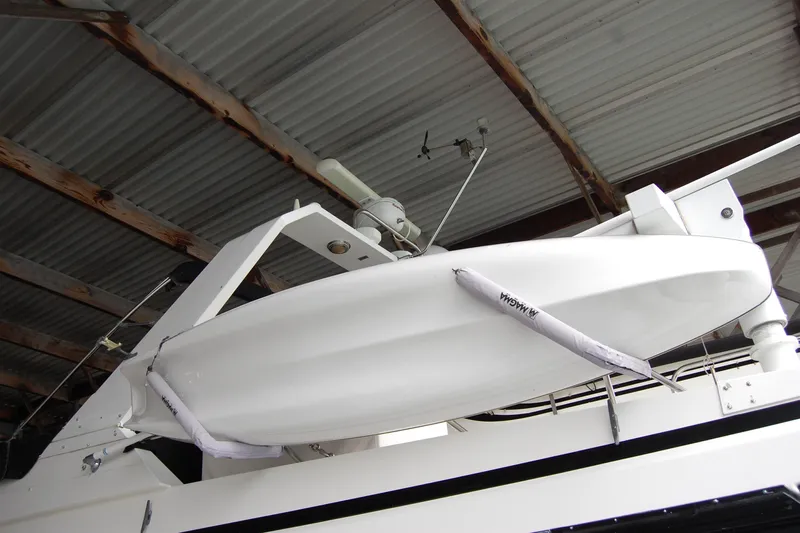 Sumptin Special Yacht Photos Pics 1990 Ocean Alexander 520 Pilothouse yacht with covered lifeboat under a metal roof.