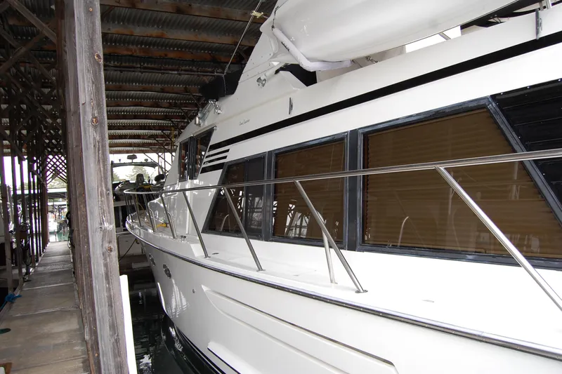 Sumptin Special Yacht Photos Pics 1990 Ocean Alexander 520 Pilothouse yacht docked in a covered marina.