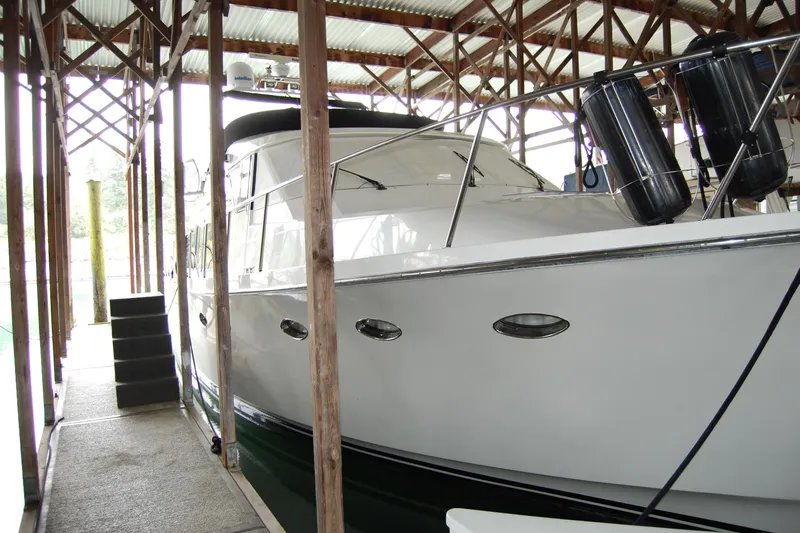 Sumptin Special Yacht Photos Pics 1990 Ocean Alexander 520 Pilothouse yacht docked in covered marina.