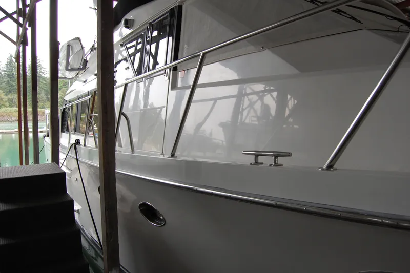 Sumptin Special Yacht Photos Pics 1990 Ocean Alexander 520 Pilothouse yacht docked in a marina, side view.