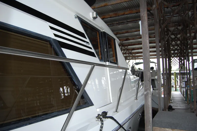 Sumptin Special Yacht Photos Pics 1990 Ocean Alexander 520 Pilothouse yacht docked in a covered marina.