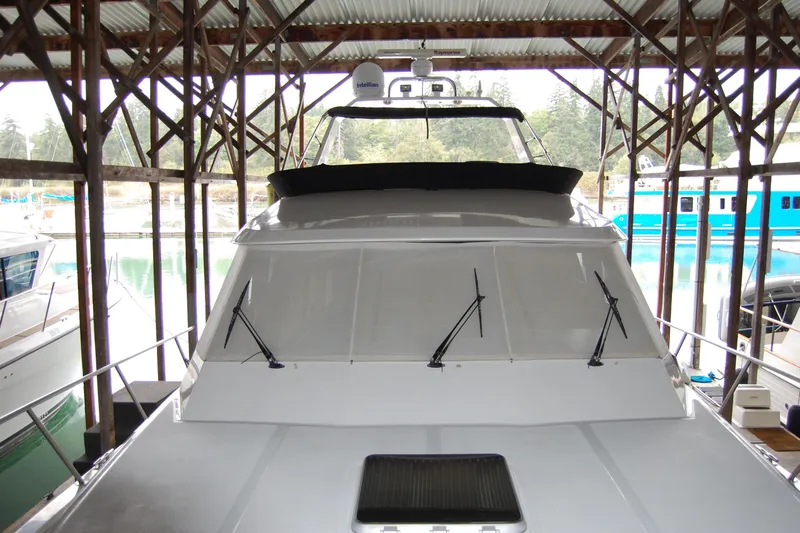 Sumptin Special Yacht Photos Pics 1990 Ocean Alexander 520 Pilothouse yacht docked in a covered marina.