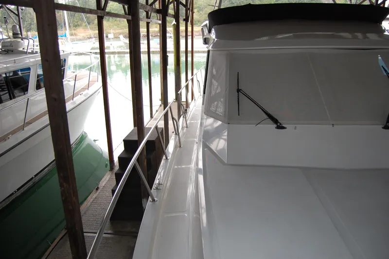 Sumptin Special Yacht Photos Pics 1990 Ocean Alexander 520 Pilothouse yacht docked in a covered marina.