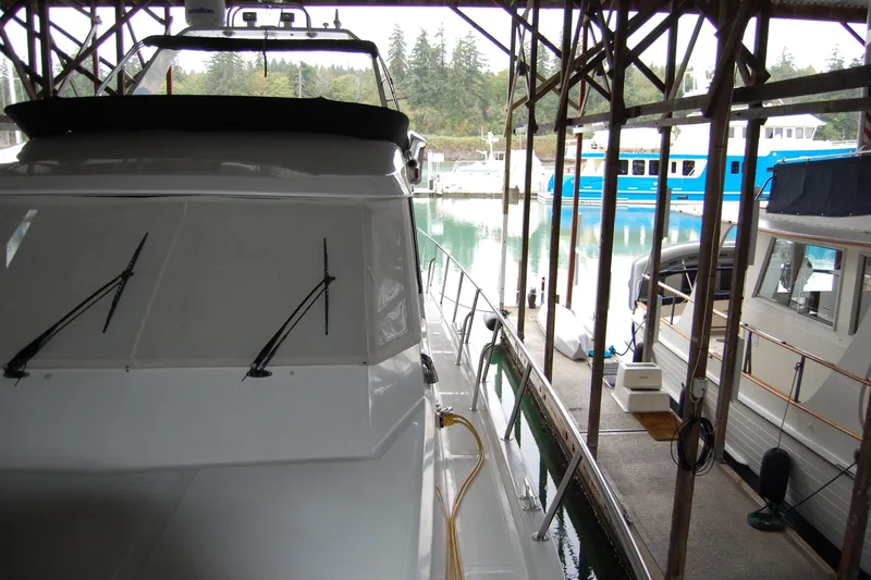 Sumptin Special Yacht Photos Pics 1990 Ocean Alexander 520 Pilothouse yacht docked in a marina, surrounded by other boats.