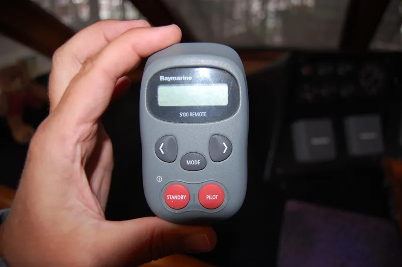 Sumptin Special Yacht Photos Pics Hand holding Raymarine S100 remote control on Ocean Alexander 520 Pilothouse, 1990 model.