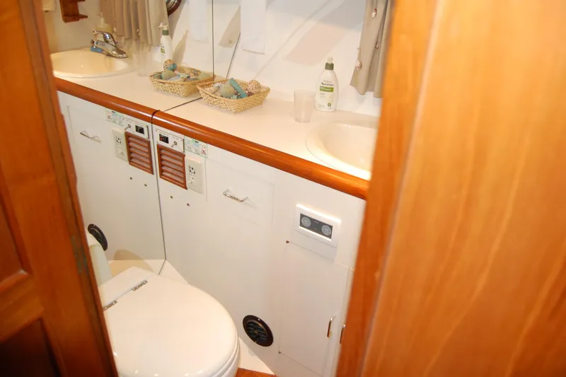 Sumptin Special Yacht Photos Pics Bathroom interior of 1990 Ocean Alexander 520 Pilothouse yacht, featuring sink and toilet.