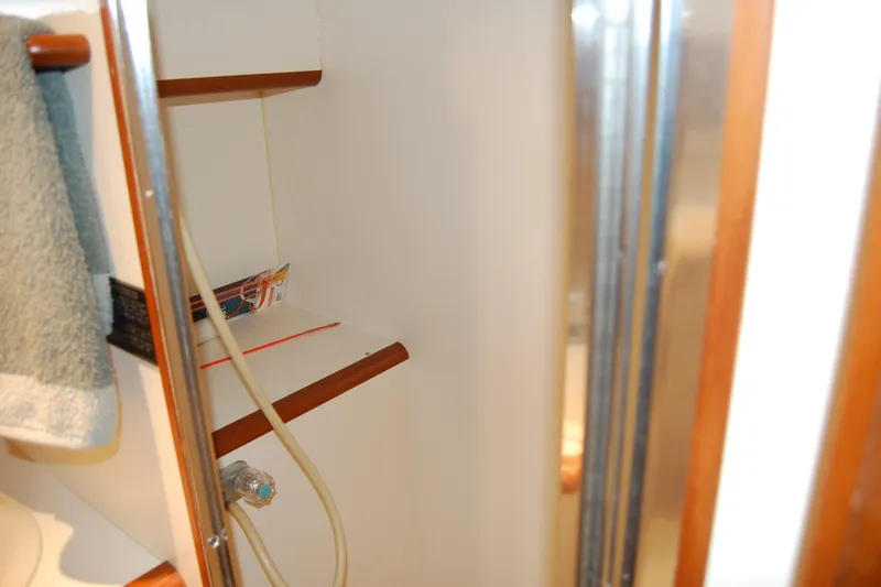 Sumptin Special Yacht Photos Pics Interior of 1990 Ocean Alexander 520 Pilothouse, featuring shelves and a towel.