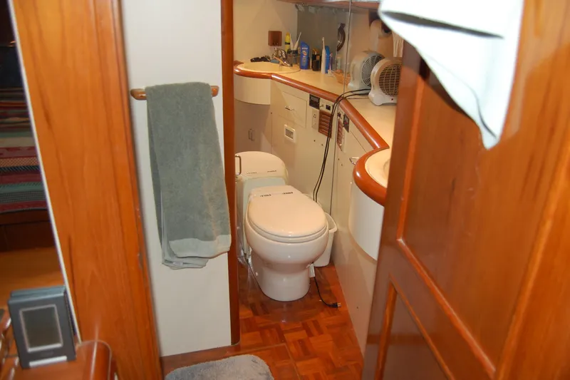 Sumptin Special Yacht Photos Pics Bathroom interior of 1990 Ocean Alexander 520 Pilothouse yacht, featuring wooden accents and modern amenities.