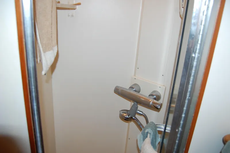 Sumptin Special Yacht Photos Pics Shower area in 1990 Ocean Alexander 520 Pilothouse yacht, featuring chrome fixtures and towel.