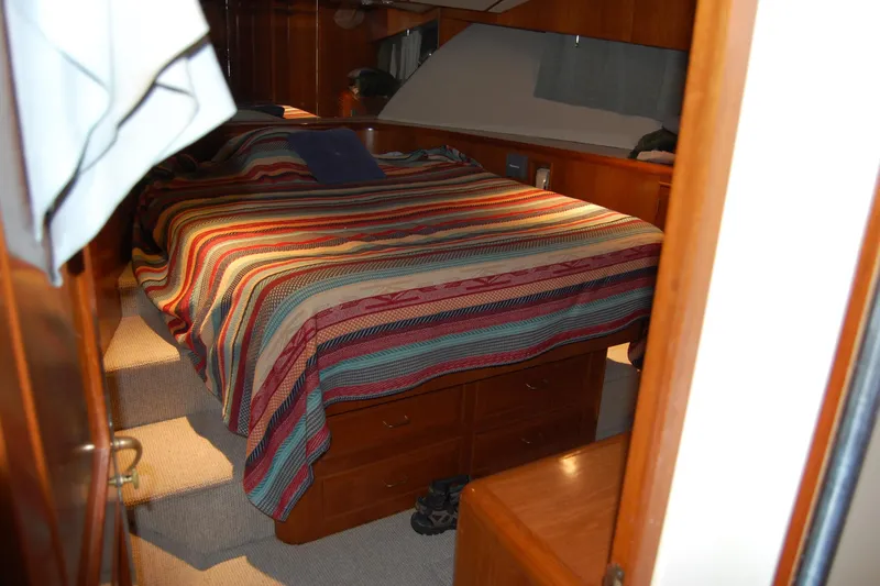 Sumptin Special Yacht Photos Pics Cozy bedroom in 1990 Ocean Alexander 520 Pilothouse yacht with striped bedding.