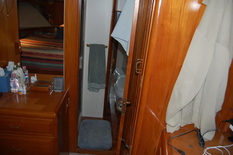 Sumptin Special Yacht Photos Pics Interior of 1990 Ocean Alexander 520 Pilothouse with wooden cabinetry and bathroom view.