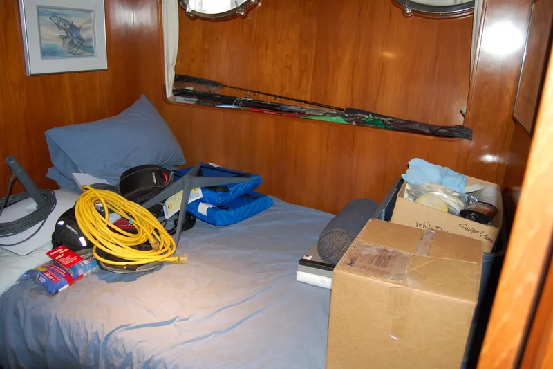 Sumptin Special Yacht Photos Pics Cozy cabin interior of 1990 Ocean Alexander 520 Pilothouse with storage items.