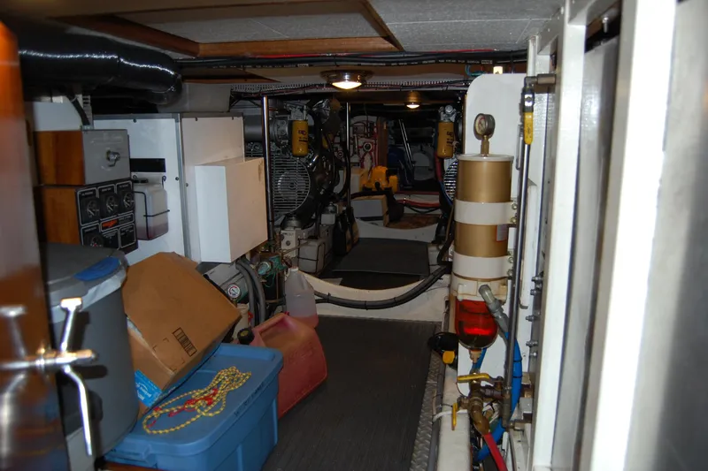 Sumptin Special Yacht Photos Pics Engine room of a 1990 Ocean Alexander 520 Pilothouse, featuring equipment and storage items.