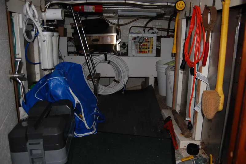 Sumptin Special Yacht Photos Pics Storage area of 1990 Ocean Alexander 520 Pilothouse with tools and equipment.