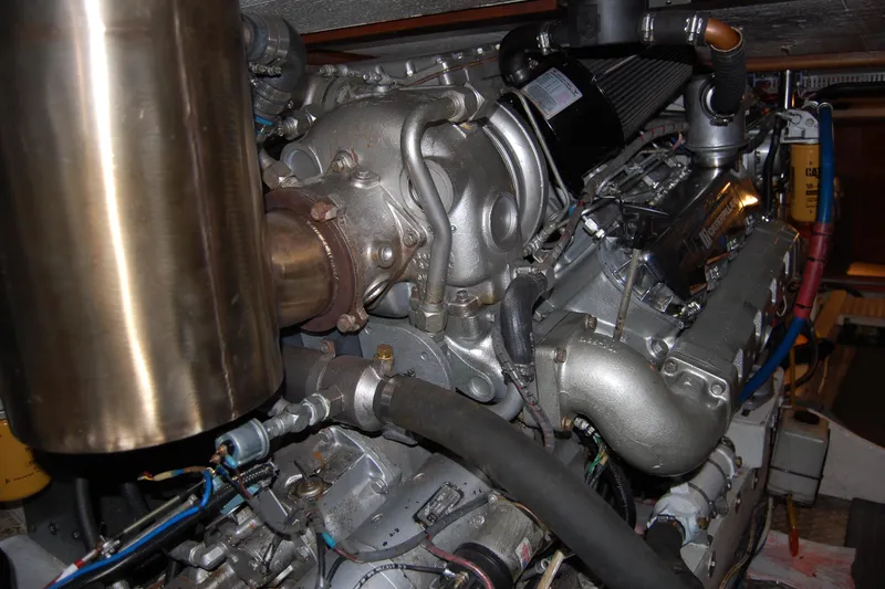 Sumptin Special Yacht Photos Pics Engine room of 1990 Ocean Alexander 520 Pilothouse yacht, showcasing detailed machinery components.