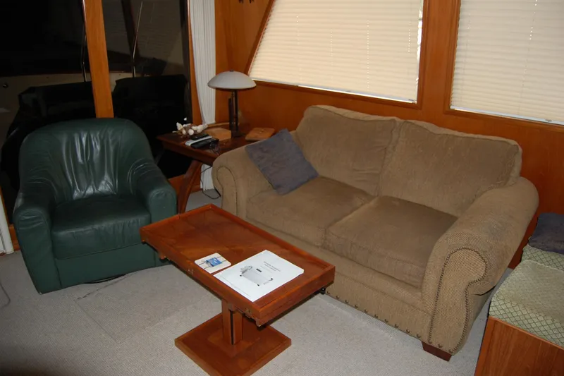 Sumptin Special Yacht Photos Pics Cozy interior of 1990 Ocean Alexander 520 Pilothouse with sofa and armchair.