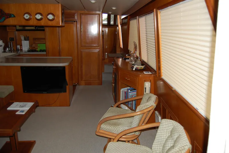 Sumptin Special Yacht Photos Pics Interior of 1990 Ocean Alexander 520 Pilothouse with wood paneling and cozy seating area.