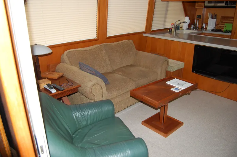 Sumptin Special Yacht Photos Pics Interior of 1990 Ocean Alexander 520 Pilothouse with cozy seating and wooden accents.