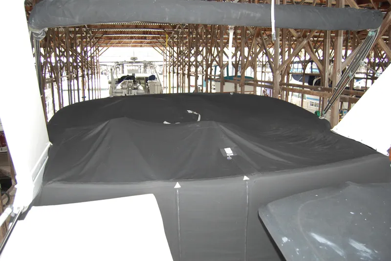 Sumptin Special Yacht Photos Pics Covered 1990 Ocean Alexander 520 Pilothouse yacht in a wooden boathouse.